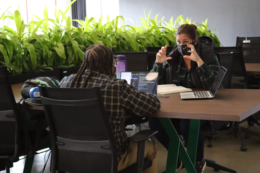 Entrepreneur speaking with their client at a co-working space called CoBiz Richmond - a beautiful co-working space with ample parking and amazing wifi.